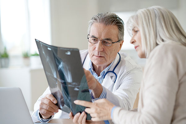 Doctor showing an xray to a patient